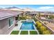 Aerial view of backyard with a gorgeous pool, spa, landscaping, and mountain views for a luxurious outdoor living space at 440 Point Sur Ave, Las Vegas, NV 89138