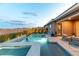 A pristine pool and spa are surrounded by a patio and greenery at 440 Point Sur Ave, Las Vegas, NV 89138