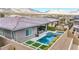 Aerial view of the backyard pool with spa, patio, and lush landscaping creates a private outdoor oasis at 440 Point Sur Ave, Las Vegas, NV 89138