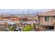 An elevated view of street with modern homes and city view at 440 Point Sur Ave, Las Vegas, NV 89138