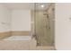 Bright bathroom featuring a separate soaking tub and glass enclosed shower with beige marble tile surround at 4575 Dean Martin Dr # 1605, Las Vegas, NV 89103