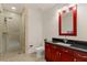 Well lit bathroom featuring a glass enclosed shower, toilet and dark wood vanity at 4575 Dean Martin Dr # 1605, Las Vegas, NV 89103