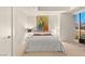 Cozy bedroom with a large bed, soft lighting, and a captivating city view through the expansive window at 4575 Dean Martin Dr # 1605, Las Vegas, NV 89103