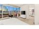 Bedroom with floor-to-ceiling windows offering stunning city views and a comfortable workspace at 4575 Dean Martin Dr # 1605, Las Vegas, NV 89103