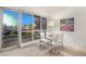 Dining area with glass table and modern chairs, featuring expansive windows with city views at 4575 Dean Martin Dr # 1605, Las Vegas, NV 89103
