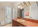Bathroom featuring unique tile counters, a large mirror, and a door to the outside at 4775 N Tee Pee Ln, Las Vegas, NV 89129