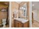 Stylish bathroom with marble countertops, a decorative mirror, and warm paint tones at 4775 N Tee Pee Ln, Las Vegas, NV 89129