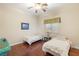 This bedroom features wood floors, two twin beds, and a ceiling fan at 4775 N Tee Pee Ln, Las Vegas, NV 89129