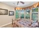 Bedroom with large windows, decorative curtains, and plush carpeting at 4775 N Tee Pee Ln, Las Vegas, NV 89129