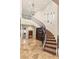 Elegant entryway with a curved staircase and decorative iron railings at 4775 N Tee Pee Ln, Las Vegas, NV 89129