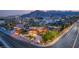 Elegant property featuring a grand driveway, well-manicured lawns, and beautiful landscaping with mountain views at 4775 N Tee Pee Ln, Las Vegas, NV 89129