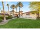 Stunning two-story home featuring a well-manicured lawn and beautiful palm trees at 4775 N Tee Pee Ln, Las Vegas, NV 89129