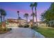 Exterior of the home with covered parking and beautiful landscaping and a desert sky backdrop at 4775 N Tee Pee Ln, Las Vegas, NV 89129
