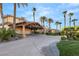 Spacious driveway leading to a covered garage, surrounded by palm trees and manicured landscaping at 4775 N Tee Pee Ln, Las Vegas, NV 89129