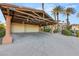Spacious three-car garage with a beautiful wooden pergola and exposed support beams at 4775 N Tee Pee Ln, Las Vegas, NV 89129