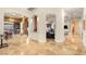 Open hallway with arched doorways and travertine flooring at 4775 N Tee Pee Ln, Las Vegas, NV 89129