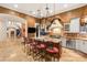 Spacious kitchen featuring a granite island, custom range hood, and stainless steel appliances at 4775 N Tee Pee Ln, Las Vegas, NV 89129