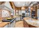 Well-appointed kitchen with professional-grade appliances, granite countertops, and custom tile backsplash at 4775 N Tee Pee Ln, Las Vegas, NV 89129