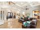 Open concept living room with tile flooring, coffered ceilings, and custom iron entry doors at 4775 N Tee Pee Ln, Las Vegas, NV 89129
