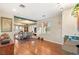 Sunlit living room boasts hardwood floors, an open floor plan, and a built-in desk for work or study at 4775 N Tee Pee Ln, Las Vegas, NV 89129