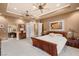 Spacious main bedroom with decorative ceiling fans, ample closet space and an archway to the ensuite bath at 4775 N Tee Pee Ln, Las Vegas, NV 89129
