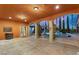 Covered patio overlooking a luxurious pool and landscaped backyard, ideal for outdoor living and entertaining at 4775 N Tee Pee Ln, Las Vegas, NV 89129