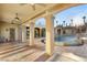 Beautiful covered patio with large columns overlooking the pool and manicured landscaping for relaxation and entertainment at 4775 N Tee Pee Ln, Las Vegas, NV 89129
