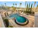 Luxury pool and patio showcasing intricate design, lush landscaping, and ample space for outdoor enjoyment at 4775 N Tee Pee Ln, Las Vegas, NV 89129