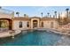 Inviting pool and patio area with water features creating a serene and luxurious outdoor space at 4775 N Tee Pee Ln, Las Vegas, NV 89129