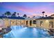 Beautiful backyard oasis with a sparkling pool, lush palm trees, and elegant architectural details at 4775 N Tee Pee Ln, Las Vegas, NV 89129