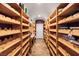 Spacious wine cellar with wooden shelving and a unique patterned ceiling at 4775 N Tee Pee Ln, Las Vegas, NV 89129