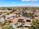 High angle shot of a residential neighborhood with desert landscaping and swimming pools at 5217 Cold River Ave, Las Vegas, NV 89130