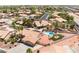 Wide aerial view showing a desert home with pool, lush landscaping, and a surrounding community at 5217 Cold River Ave, Las Vegas, NV 89130