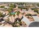 Expansive overhead view showing desert home with driveway, tropical landscaping, and neighboring houses at 5217 Cold River Ave, Las Vegas, NV 89130