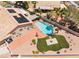 Aerial view of an inviting backyard with a sparkling pool, patio area, solar panels and artificial turf at 5217 Cold River Ave, Las Vegas, NV 89130