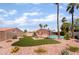 Wide backyard featuring a refreshing pool, lush lawn, mature trees, desert landscaping, and ample lounging space at 5217 Cold River Ave, Las Vegas, NV 89130