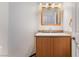 Bathroom with a wood vanity, grey countertop, and decorative mirror at 5217 Cold River Ave, Las Vegas, NV 89130