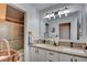 Bathroom featuring a double sink vanity with modern fixtures, lighting and a walk-in shower at 5217 Cold River Ave, Las Vegas, NV 89130