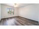 This bedroom features wood flooring and a ceiling fan at 5217 Cold River Ave, Las Vegas, NV 89130