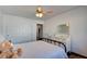 Bright bedroom with white walls, wood-look floors, mirrored dresser and ample closet space at 5217 Cold River Ave, Las Vegas, NV 89130