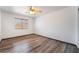 This spacious bedroom features new hardwood flooring and a ceiling fan at 5217 Cold River Ave, Las Vegas, NV 89130