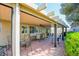 Comfortable seating area under a covered patio with ceiling fan, perfect for outdoor dining and relaxation at 5217 Cold River Ave, Las Vegas, NV 89130