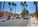 Gated community entrance with desert landscaping and palm tree lined street at 5217 Cold River Ave, Las Vegas, NV 89130