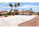 Charming single-story home with a spacious driveway and desert landscaping, complemented by tall palm trees at 5217 Cold River Ave, Las Vegas, NV 89130