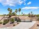 Beautiful single-story home featuring a three car garage, desert landscaping and a long drive way at 5217 Cold River Ave, Las Vegas, NV 89130