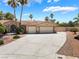 Beautiful single-story home featuring a three car garage, desert landscaping and a long drive way at 5217 Cold River Ave, Las Vegas, NV 89130