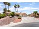 Charming single-story home with a spacious driveway and desert landscaping featuring palm trees at 5217 Cold River Ave, Las Vegas, NV 89130