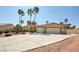 Charming single-story home with palm trees and a large driveway leading to a two-car garage at 5217 Cold River Ave, Las Vegas, NV 89130