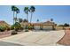 Charming single-story home with palm trees and a large driveway leading to a two-car garage at 5217 Cold River Ave, Las Vegas, NV 89130
