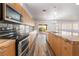 Kitchen view showcasing a modern oven, island sink, and sliding glass door to the back at 5217 Cold River Ave, Las Vegas, NV 89130